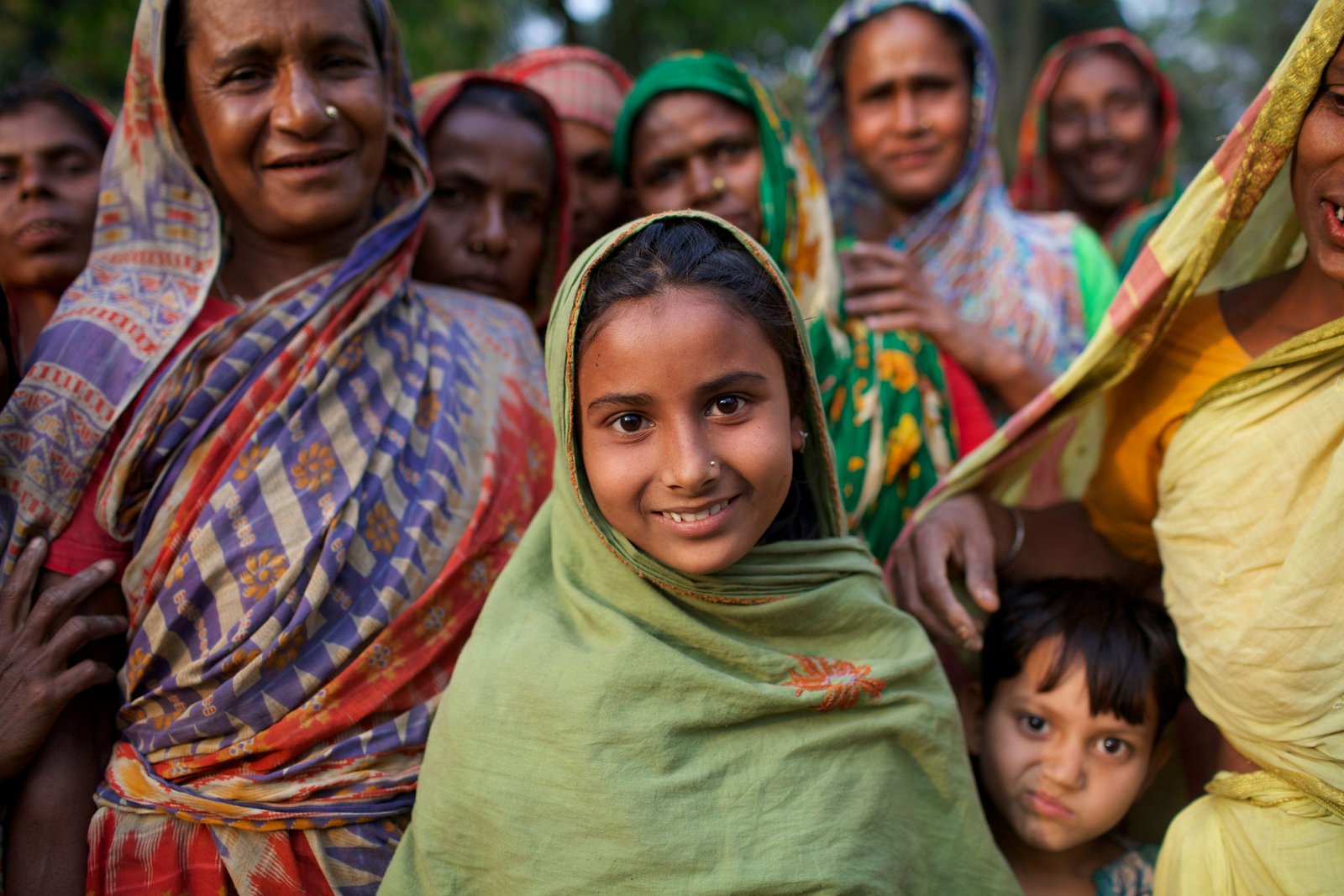 Women and children from the community gathered outdoors