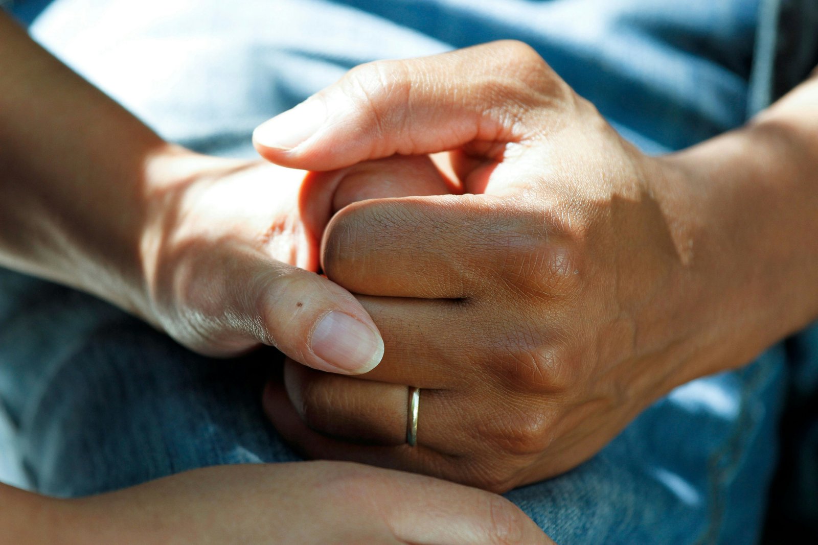 Hands holding in a gesture of support and trust