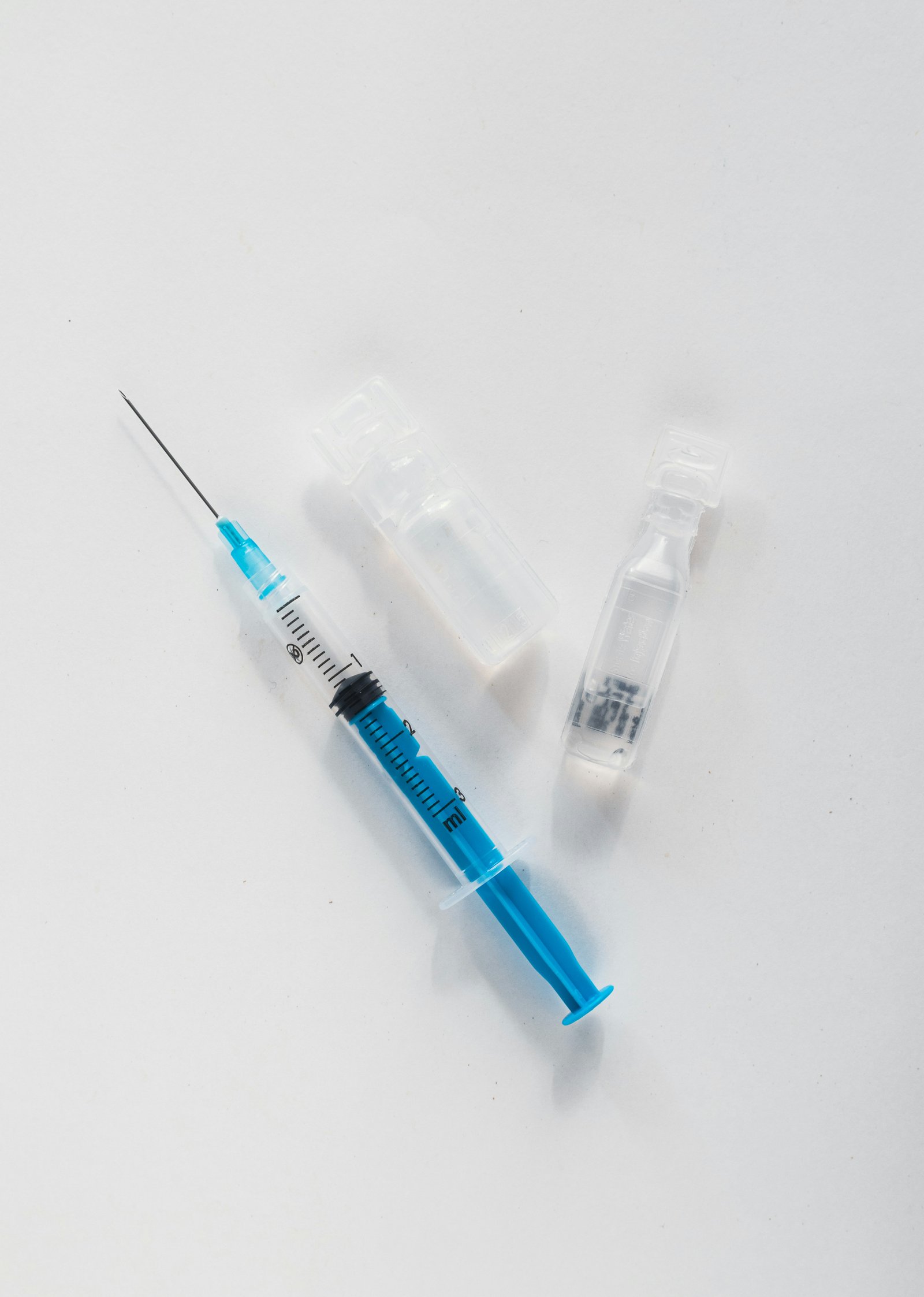 Medical syringe and ampoules representing vaccination and clinical care